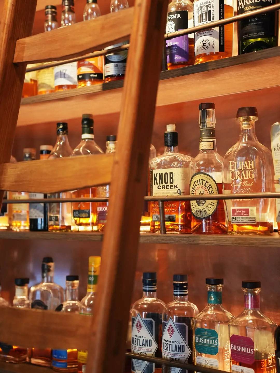 The back-bar bottle shelf at The Iron Lady